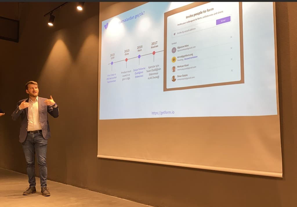 Mertcan speaking at a conference